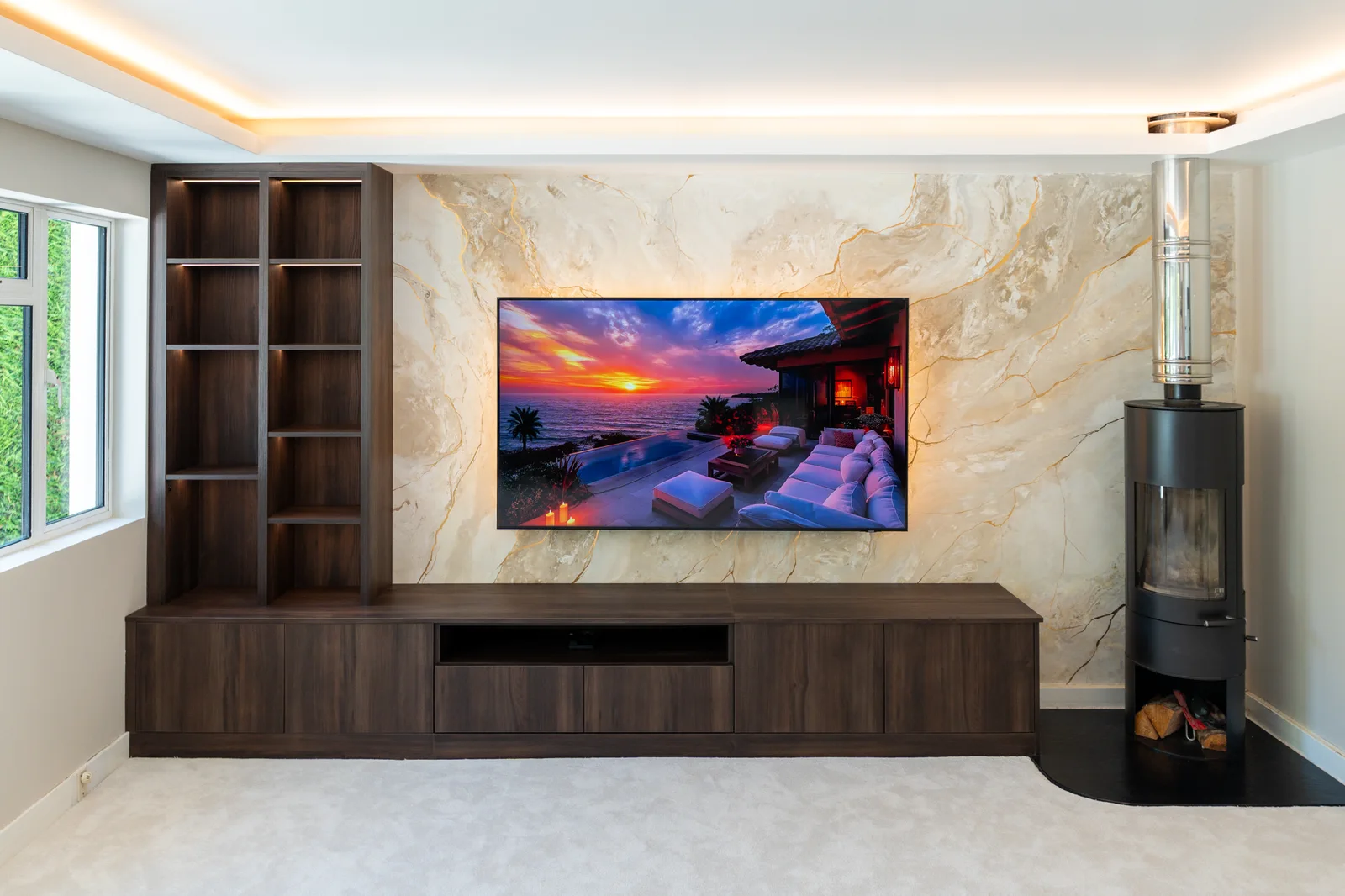 Gold-veined pale television feature wall with dark timber cabinetry and freestanding stove