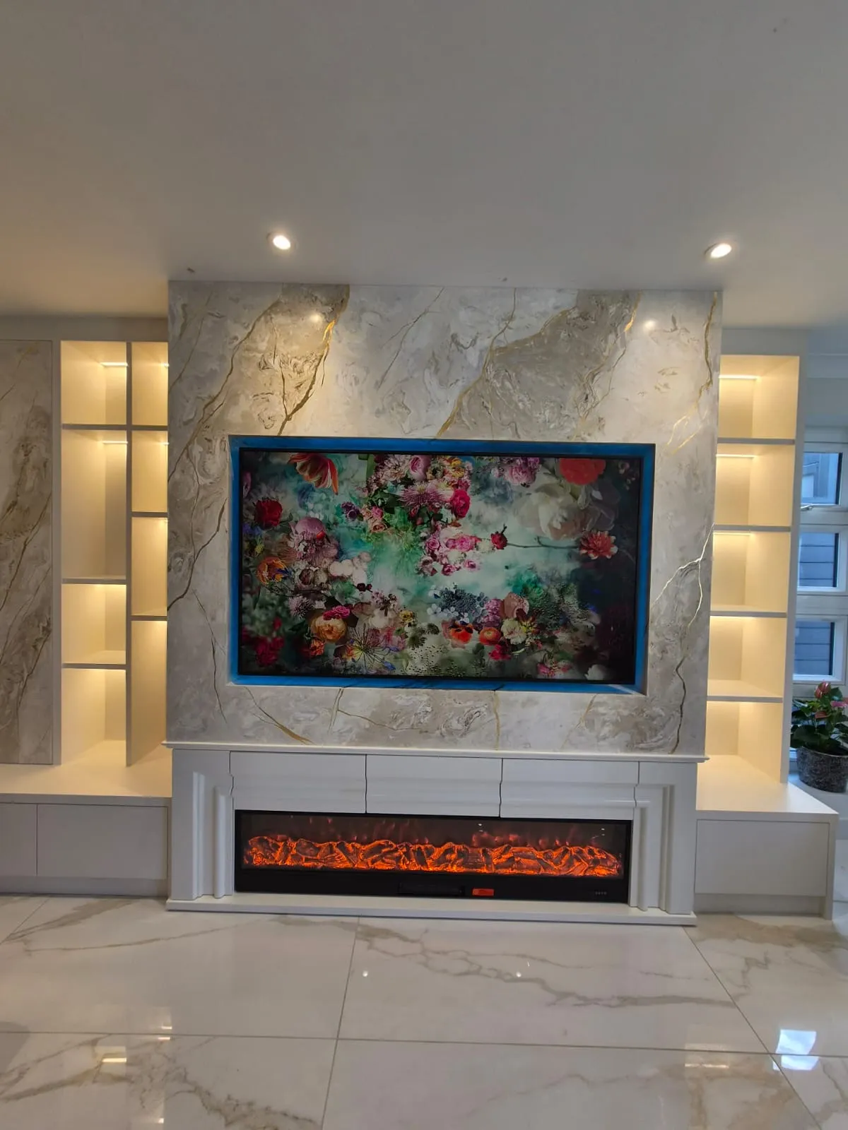 The same Hertfordshire wall finished in Venetian plaster, TV recessed above the fireplace that was retained