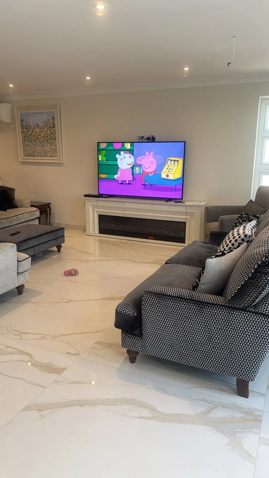 Hertfordshire living room before the build, with the TV sat on top of the existing fireplace mantel and cabling on show